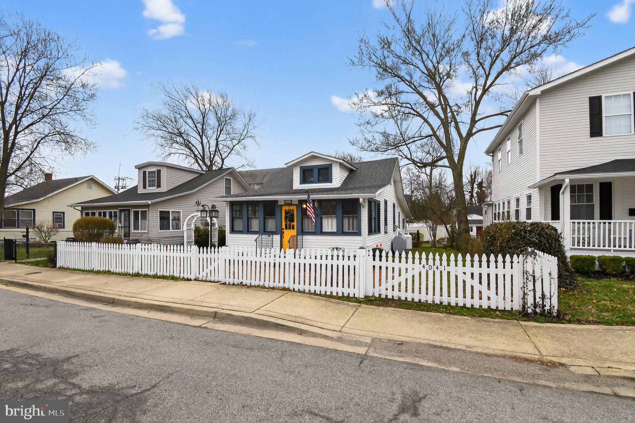 4041 7th Street North Beach, MD 20714 - Photo 1 of 35 a front view of a house with a garden