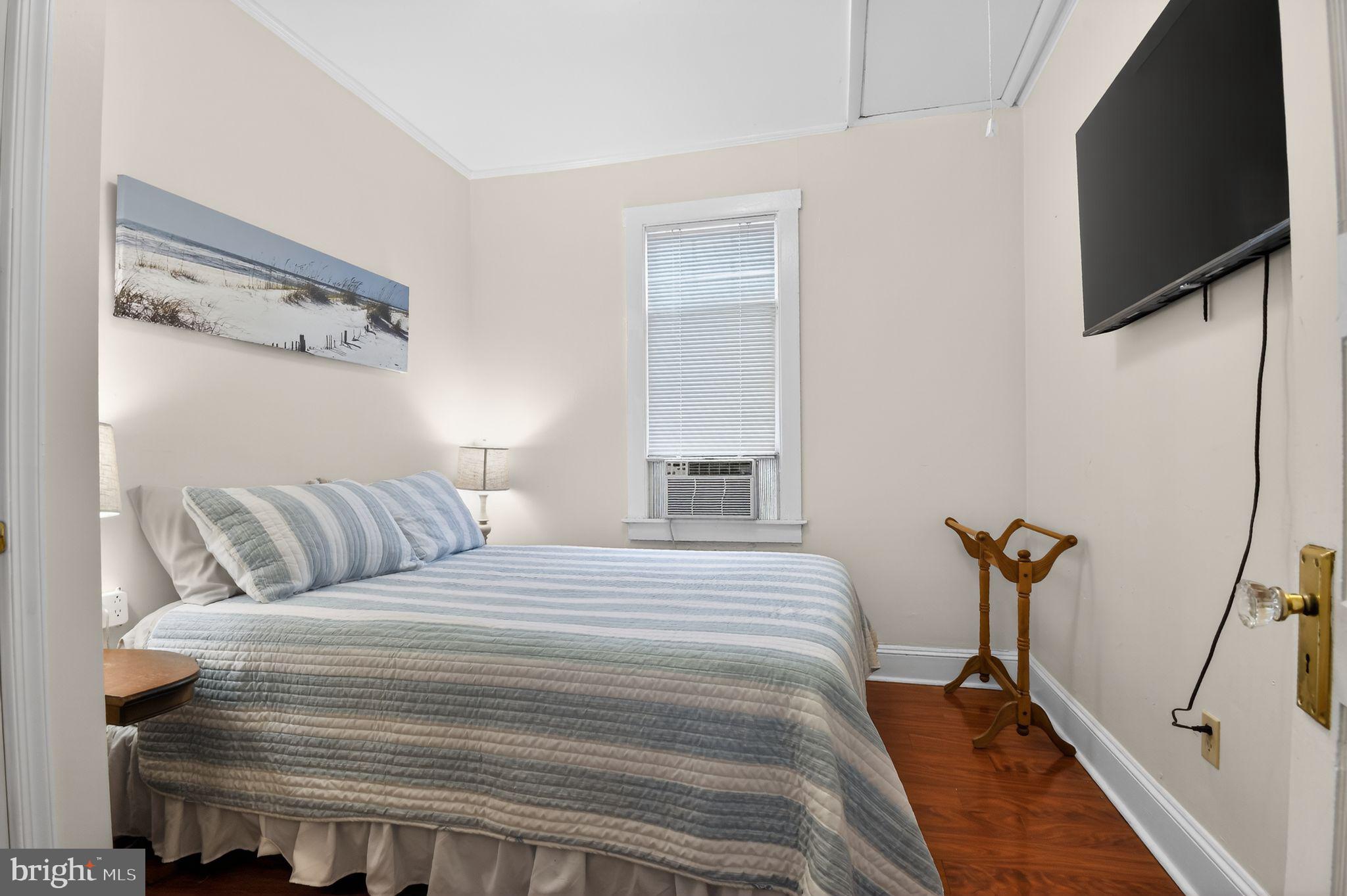 4041 7th Street North Beach, MD 20714 - Photo 14 of 35 a bedroom with a bed and a flat screen tv