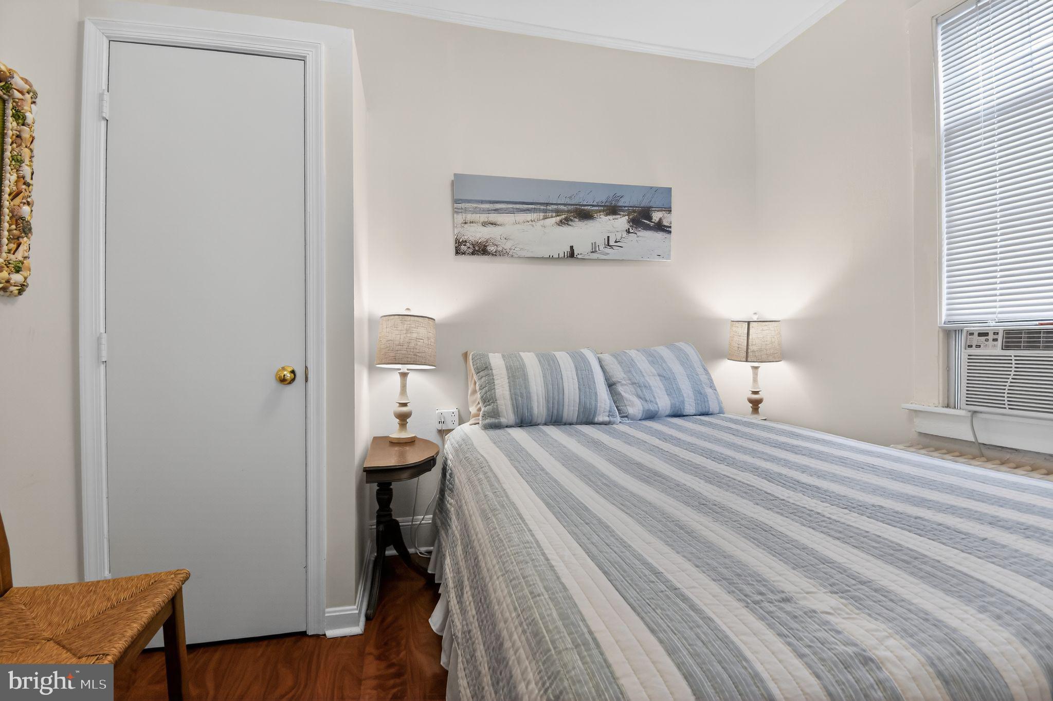 4041 7th Street North Beach, MD 20714 - Photo 15 of 35 a bed room with a bed and a lamp