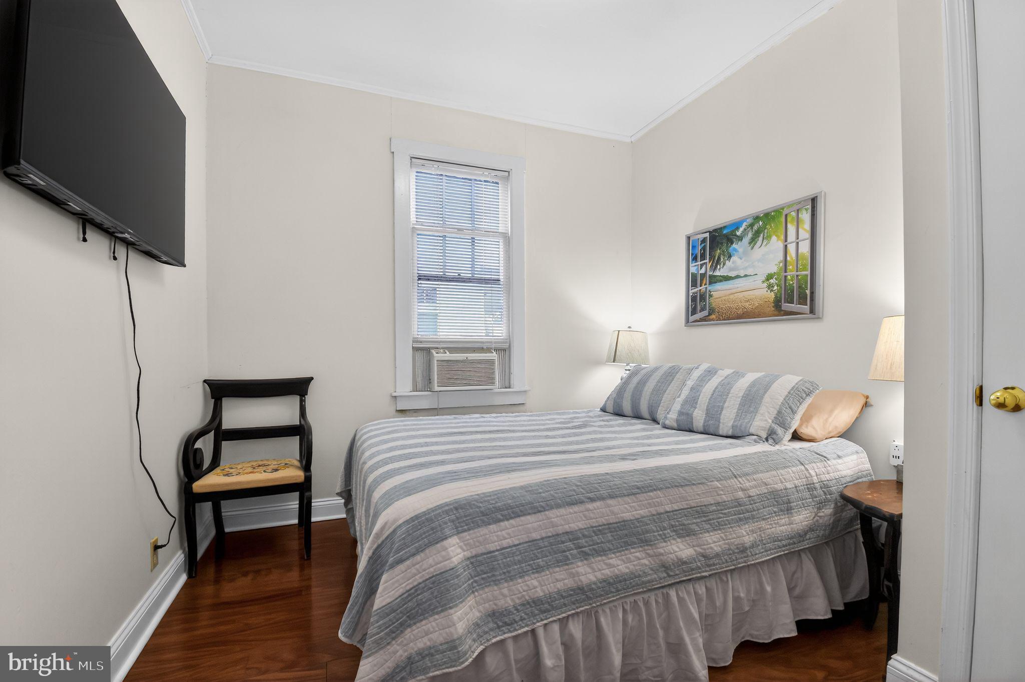 4041 7th Street North Beach, MD 20714 - Photo 16 of 35 a bedroom with a bed and a flat screen tv