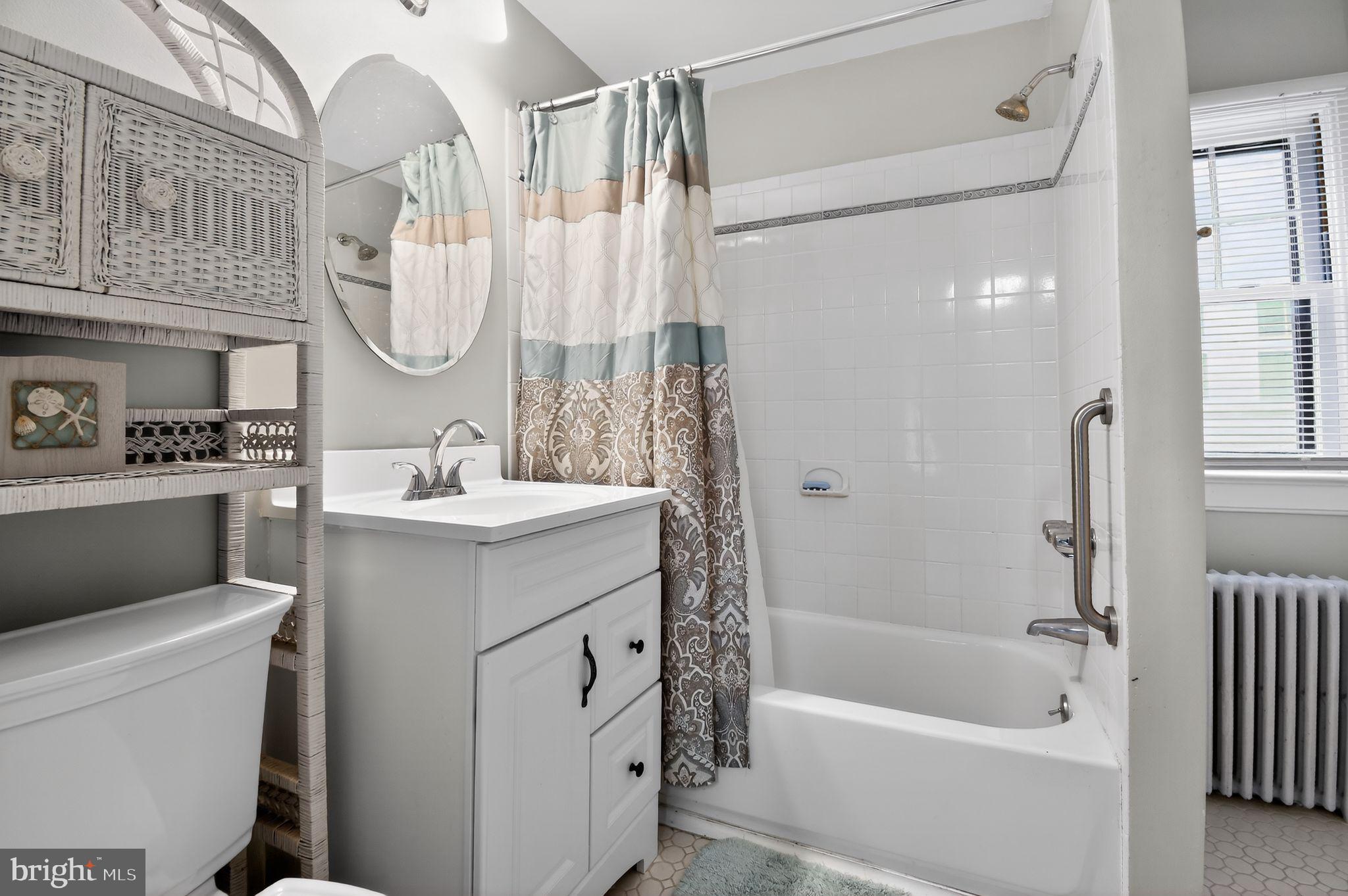 4041 7th Street North Beach, MD 20714 - Photo 18 of 35 a bathroom with a sink a toilet and a bathtub