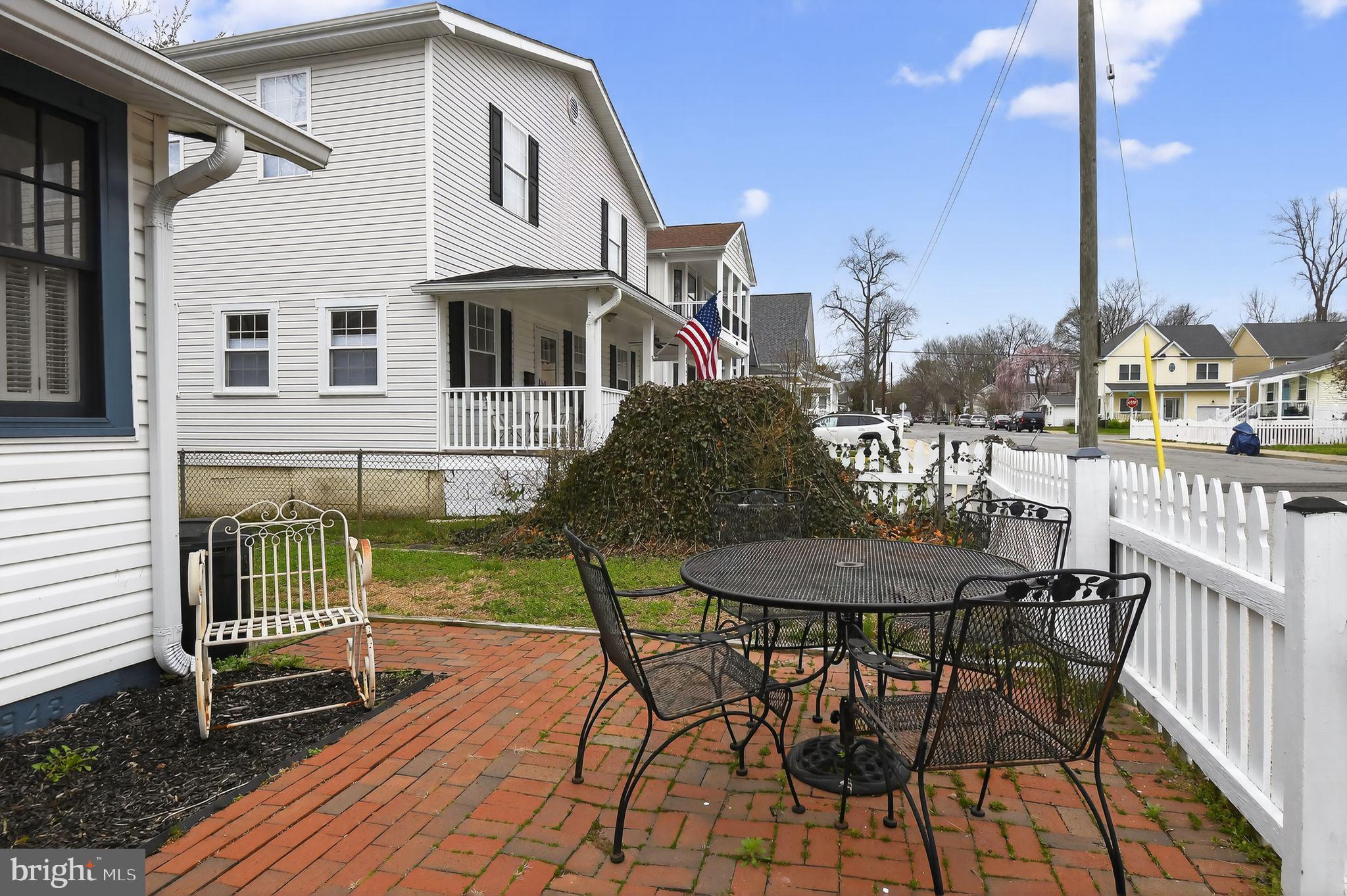 4041 7th Street North Beach, MD 20714 - Photo 2 of 35 a view of a patio with table and chairs with wooden floor and fence