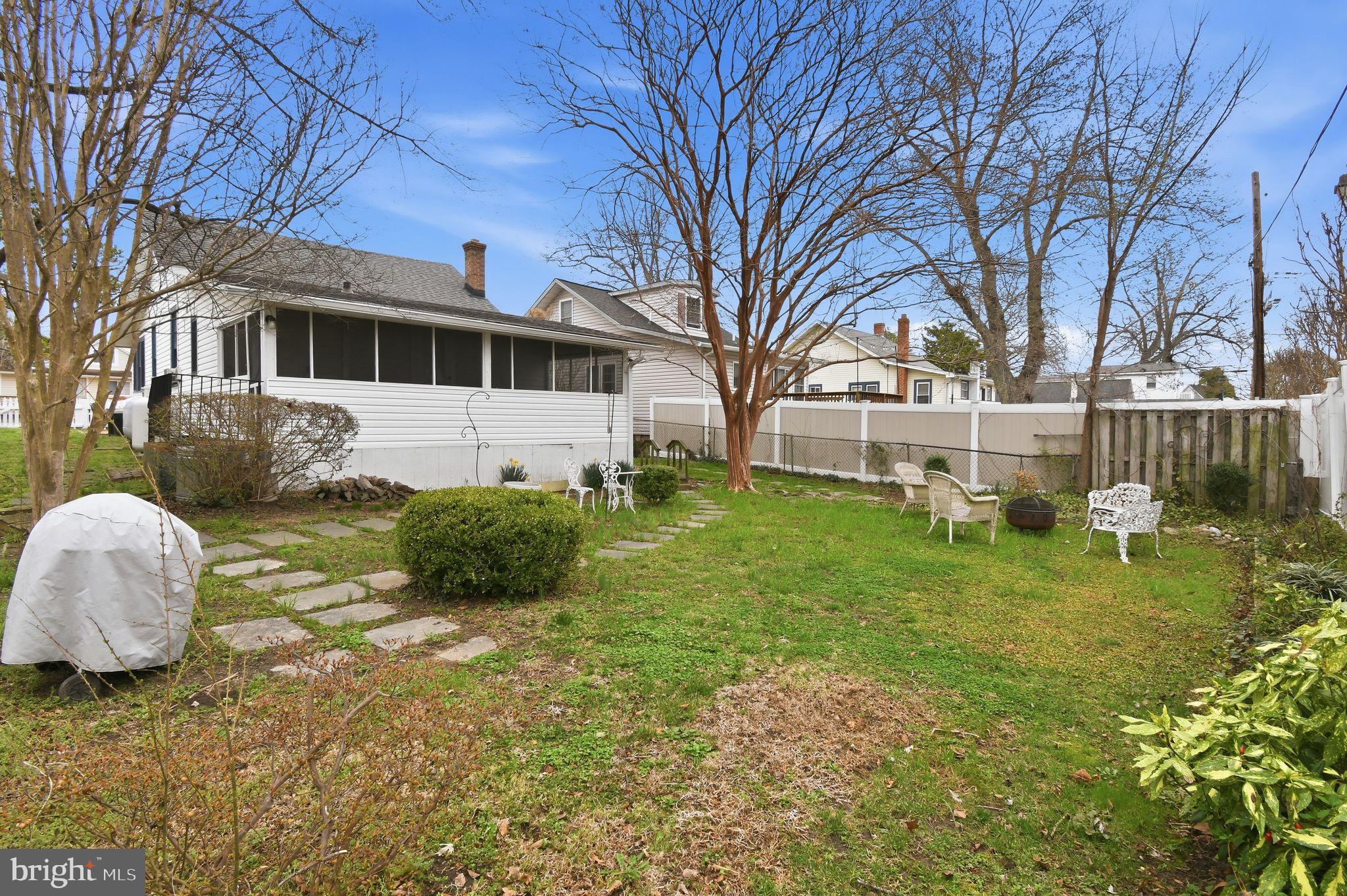 4041 7th Street North Beach, MD 20714 - Photo 25 of 35 a front view of a house with garden