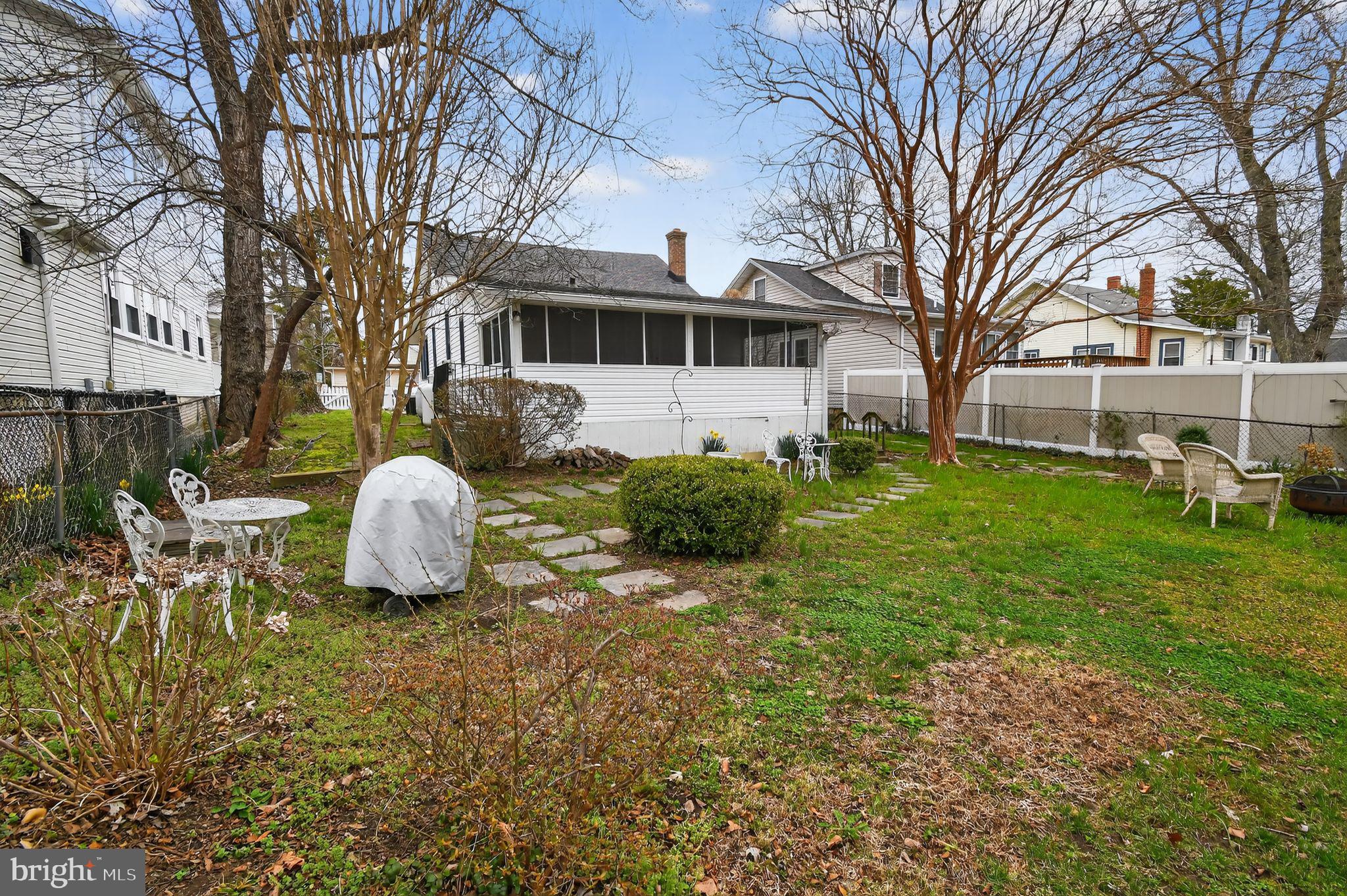 4041 7th Street North Beach, MD 20714 - Photo 27 of 35 a front view of a house with garden