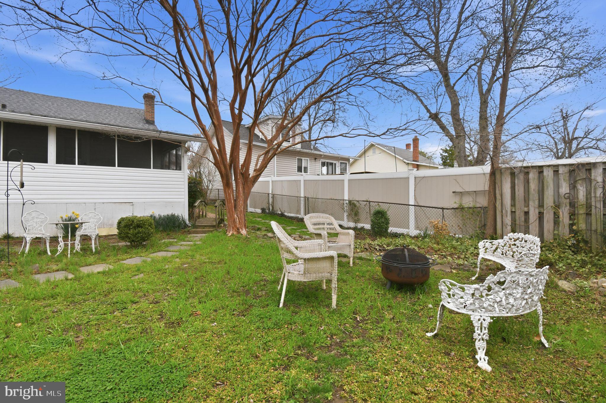 4041 7th Street North Beach, MD 20714 - Photo 30 of 35 a front view of a house with garden and chairs