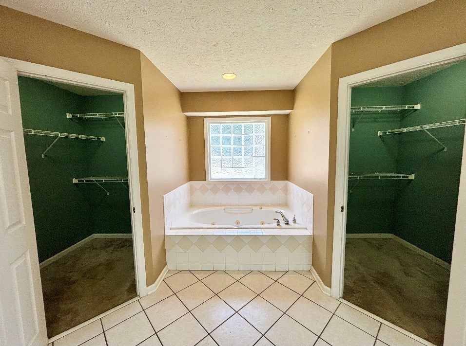205 Morton Court Fortson, GA 31808 - Photo 13 of 23 a bathroom with a tub and shower