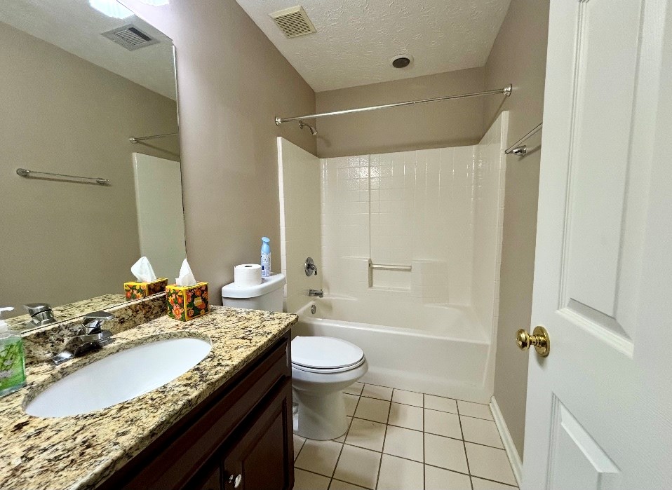 205 Morton Court Fortson, GA 31808 - Photo 18 of 23 a bathroom with a granite countertop sink mirror vanity and toilet