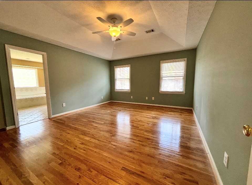 205 Morton Court Fortson, GA 31808 - Photo 8 of 23 an empty room with wooden floor and windows