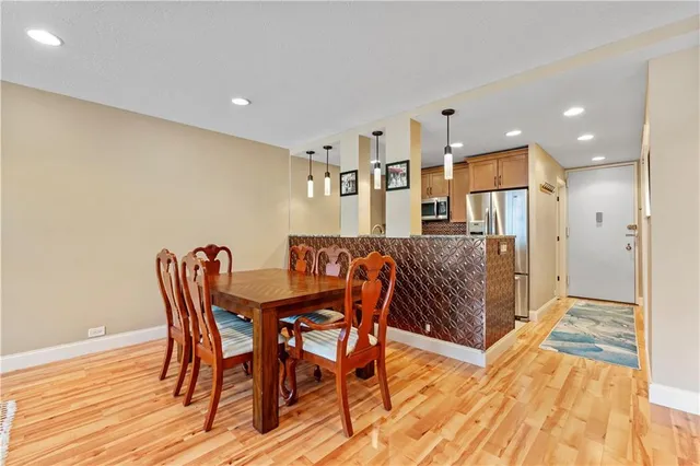a dining room with furniture and wooden floor