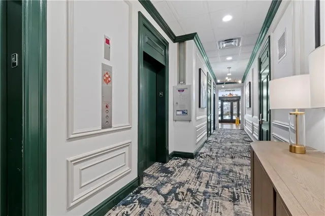 a hallway with a large kitchen stove and refrigerator