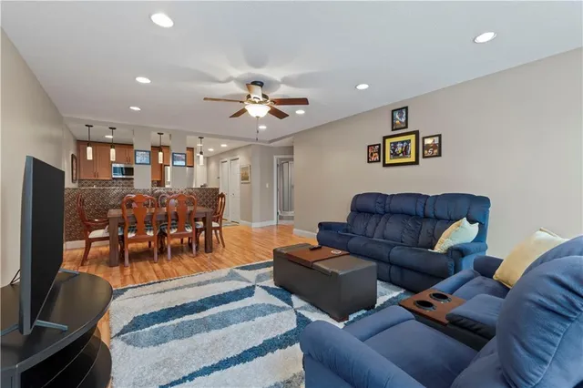 a living room with furniture and a chandelier