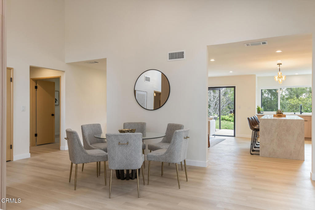 11772 Monte Leon Way Porter Ranch, CA 91326 - Photo 12 of 58 a view of a dining room with furniture window and wooden floor