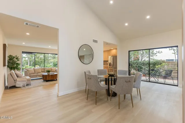 a view of a dining room with furniture a chandelier and wooden floor