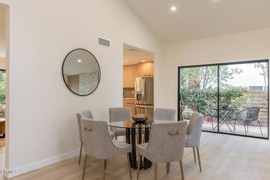 11772 Monte Leon Way Porter Ranch, CA 91326 - Photo 14 of 58 a view of a dining room with furniture a chandelier and wooden floor