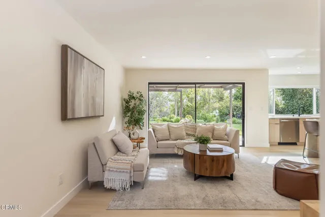 a living room with furniture and kitchen view
