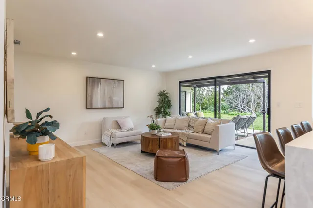 a kitchen with a dining table chairs sink and cabinets