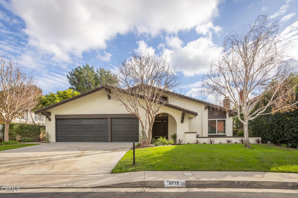 11772 Monte Leon Way Porter Ranch, CA 91326 - Photo 2 of 58 a view of a white house with a large tree and wooden fence
