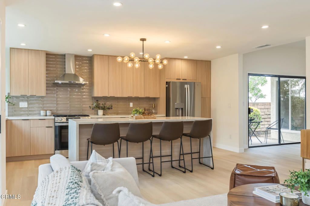 11772 Monte Leon Way Porter Ranch, CA 91326 - Photo 22 of 58 a kitchen with a table chairs sink and cabinets