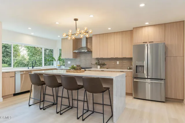 a kitchen with a stove a sink and a refrigerator