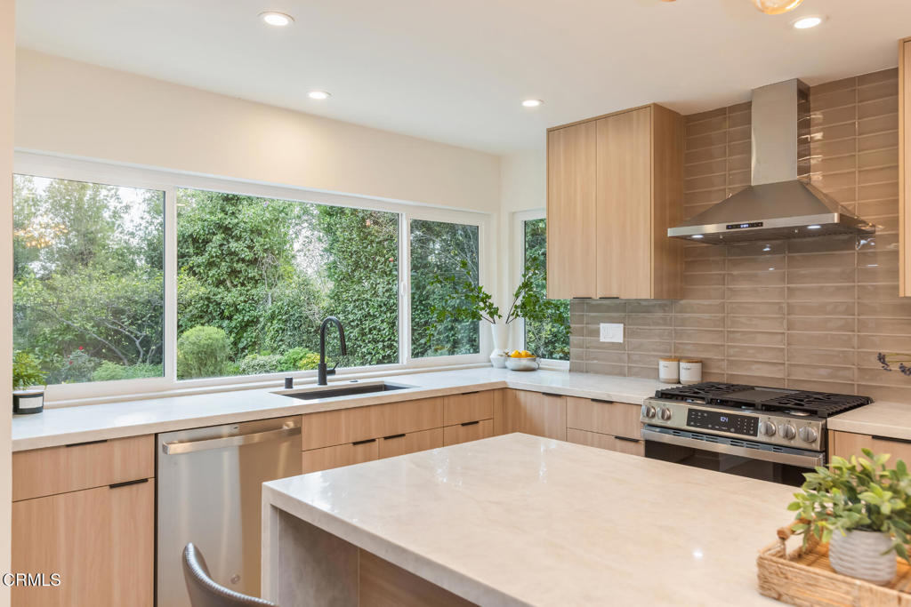 11772 Monte Leon Way Porter Ranch, CA 91326 - Photo 24 of 58 a kitchen with a stove a sink and a refrigerator