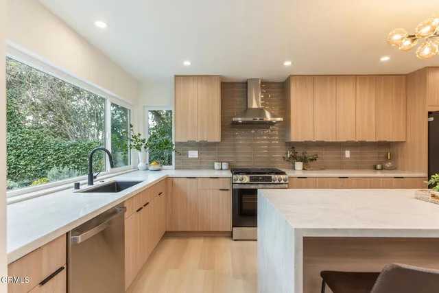 a kitchen with sink a stove and cabinets