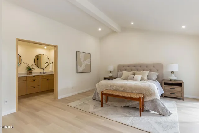 a spacious bedroom with a bed and a large window