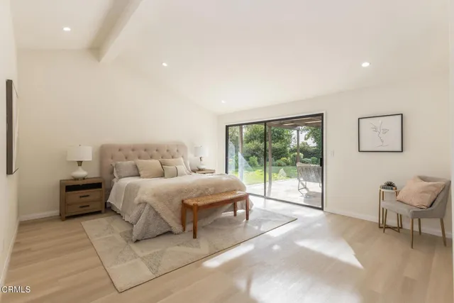 a spacious bedroom with a large bed and a large window