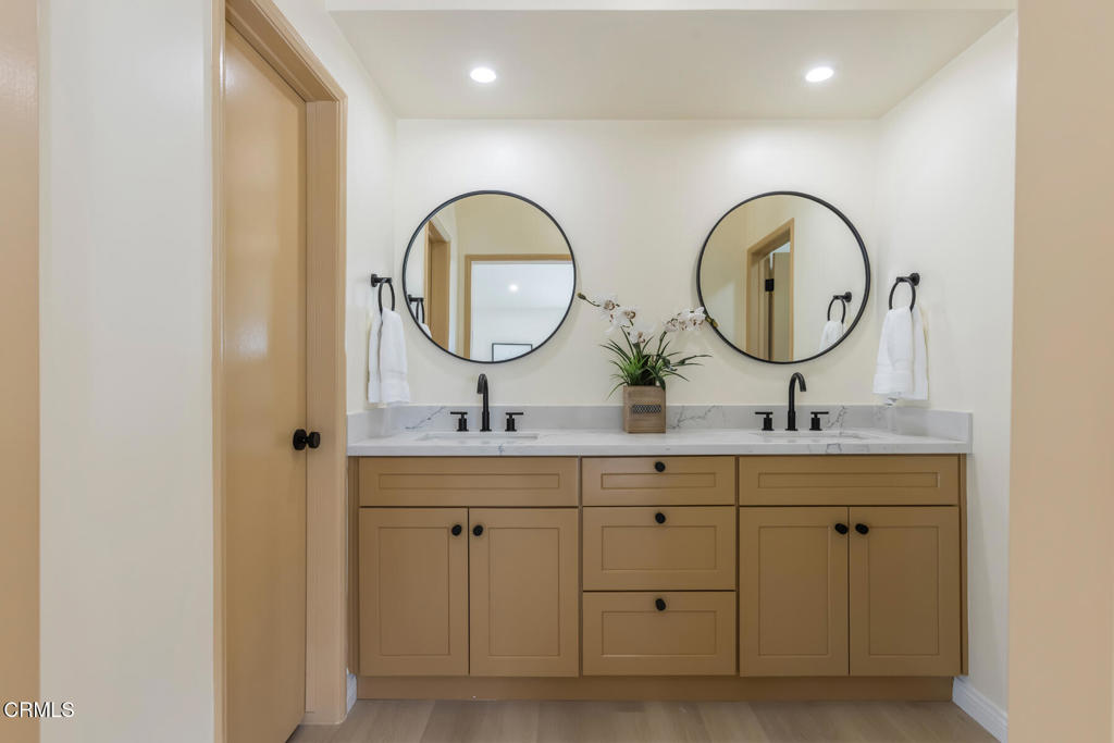 11772 Monte Leon Way Porter Ranch, CA 91326 - Photo 35 of 58 a bathroom with a double vanity sink and a mirror