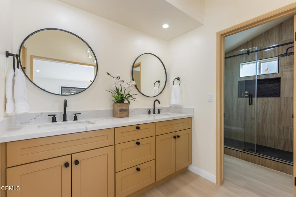 11772 Monte Leon Way Porter Ranch, CA 91326 - Photo 36 of 58 a bathroom with a granite countertop double vanity sink and a mirror