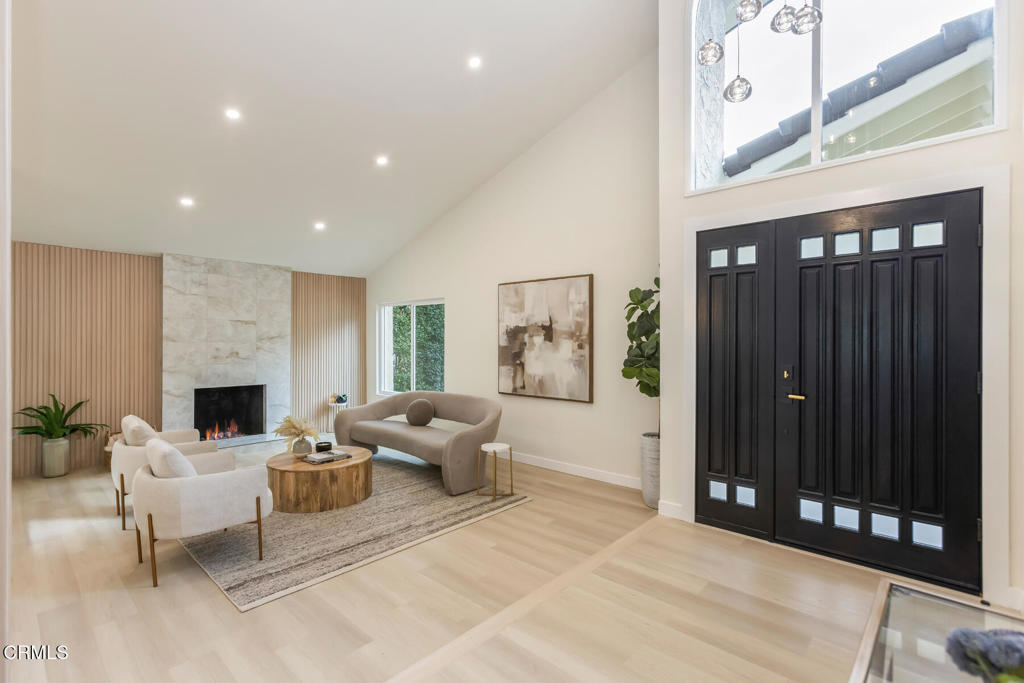 11772 Monte Leon Way Porter Ranch, CA 91326 - Photo 4 of 58 a living room with furniture a fireplace and a potted plant