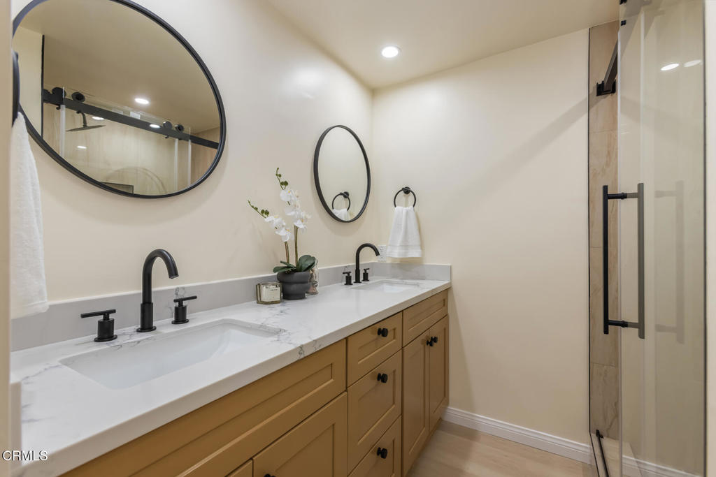 11772 Monte Leon Way Porter Ranch, CA 91326 - Photo 44 of 58 a bathroom with a double vanity sink and a mirror