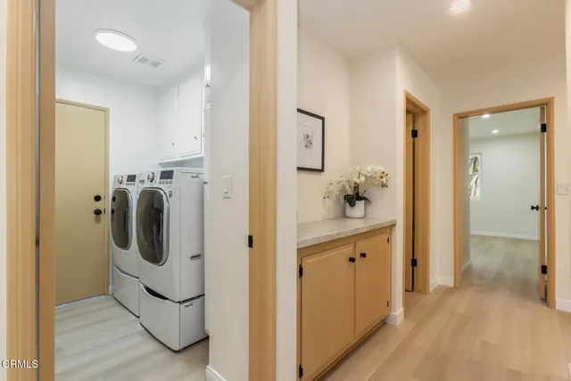 a front view of a house with a garden and trees
