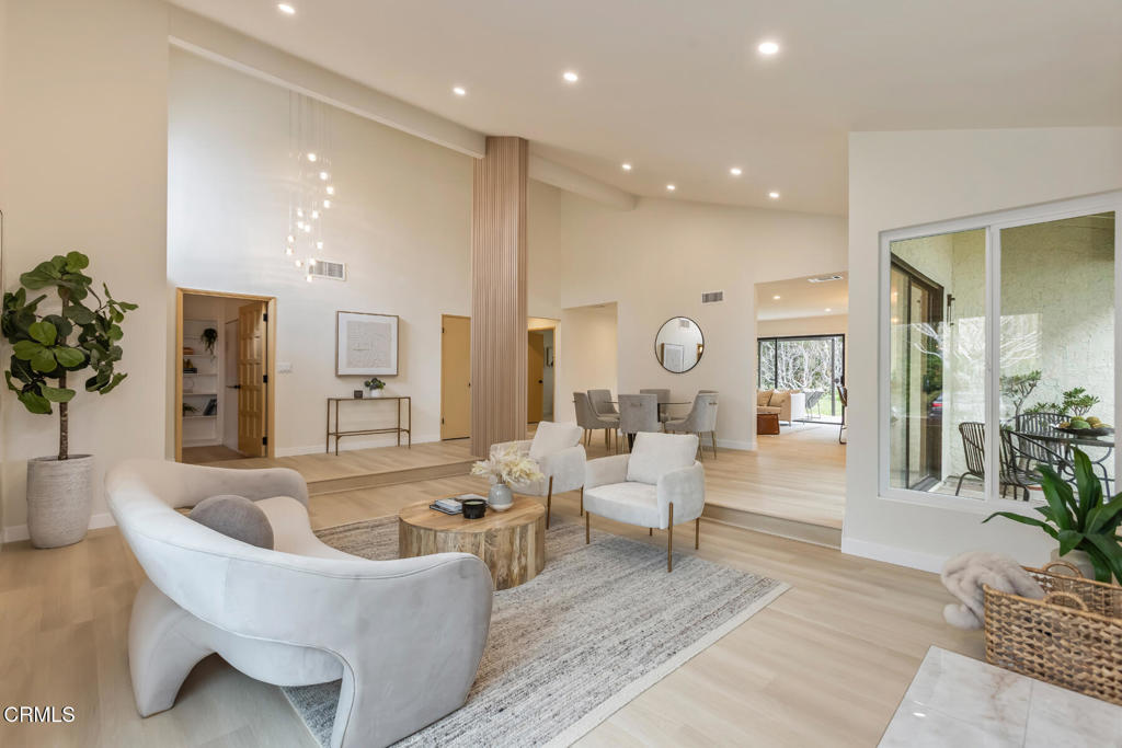 11772 Monte Leon Way Porter Ranch, CA 91326 - Photo 9 of 58 a living room with furniture potted plant and a large mirror