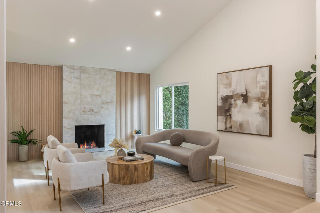 11772 Monte Leon Way Porter Ranch, CA 91326 - Photo 10 of 58 a living room with furniture and a fireplace