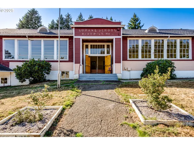 an aerial view of a house with a yard basket ball court and outdoor seating