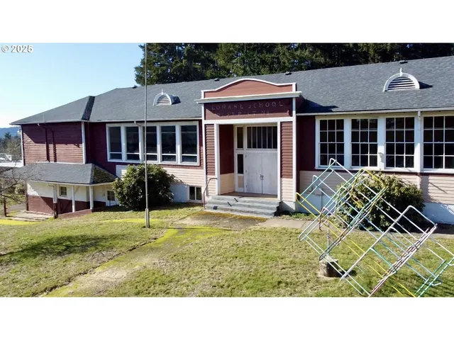 a aerial view of a house with a yard and mountain view