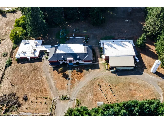 an aerial view of a house with a yard