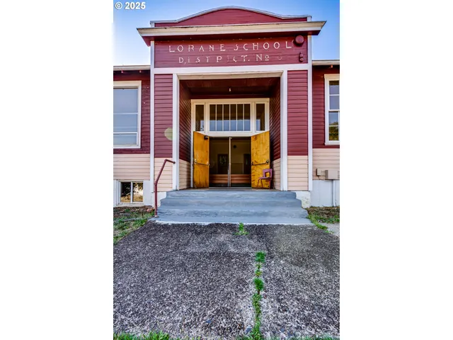 a front view of a house with a yard covered in snow