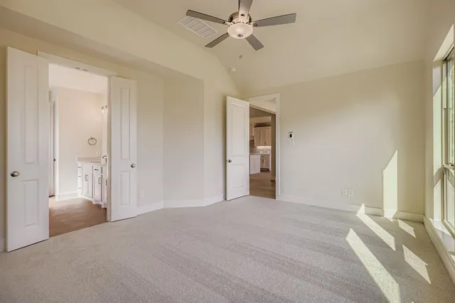a view of a room with a stylish ceiling fan and entryway