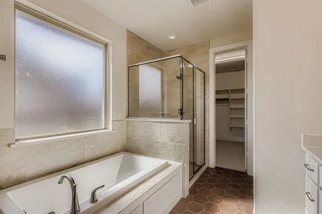 a bathroom with a tub and a shower