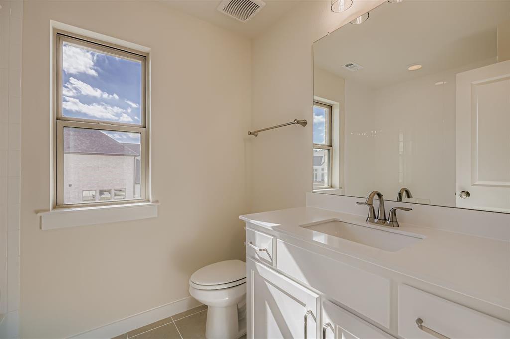4412 Cotton Seed Way Prosper, TX 75078 - Photo 21 of 29 a bathroom with a sink a toilet and a mirror