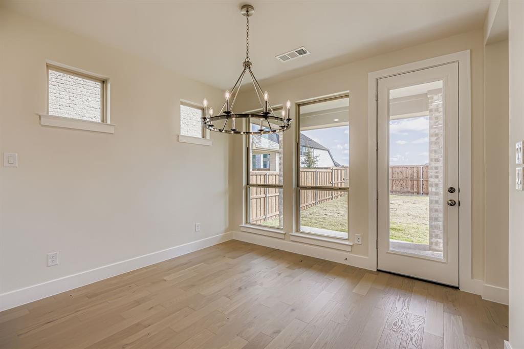 4412 Cotton Seed Way Prosper, TX 75078 - Photo 9 of 29 a view of an empty room with wooden floor and a window