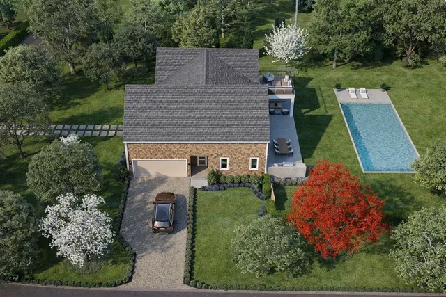 an aerial view of a house with garden space and street view
