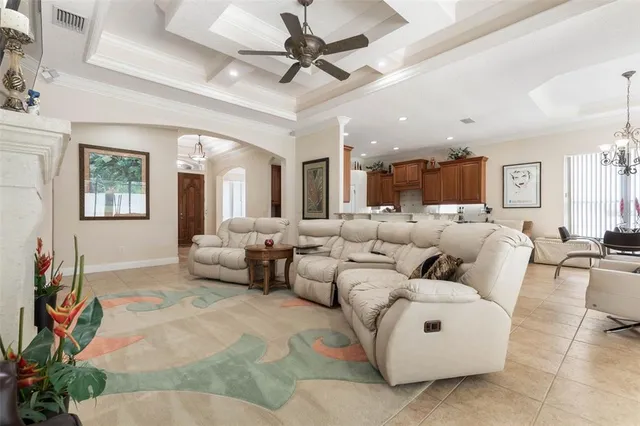 a living room with furniture a flat screen tv and a large window
