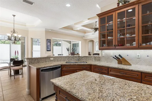 a view of a hallway with a livingroom and a dinning area with furniture