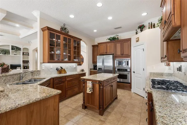 a bathroom with a granite countertop sink a mirror and a bathtub