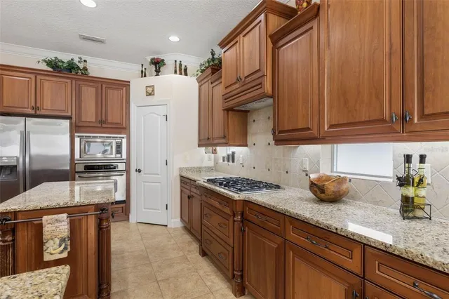 a bathroom with a granite countertop sink a toilet and a bathtub