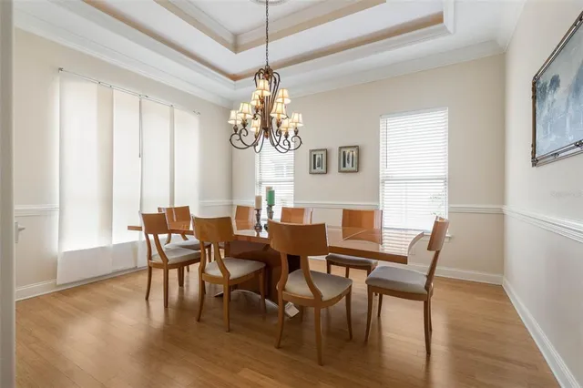 a living room with furniture a flat screen tv and a large window