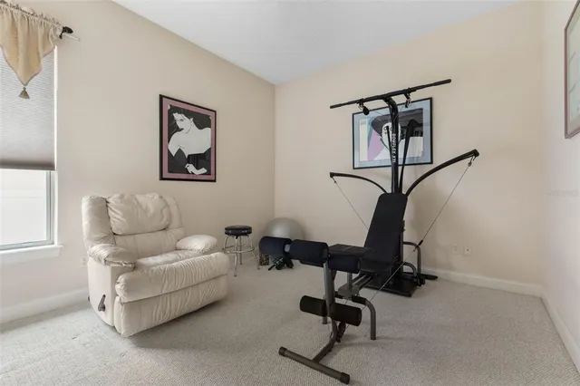 a living room with furniture and large windows