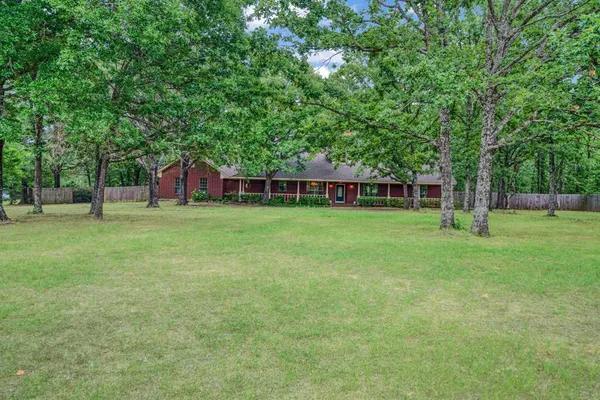 a view of a house with a backyard